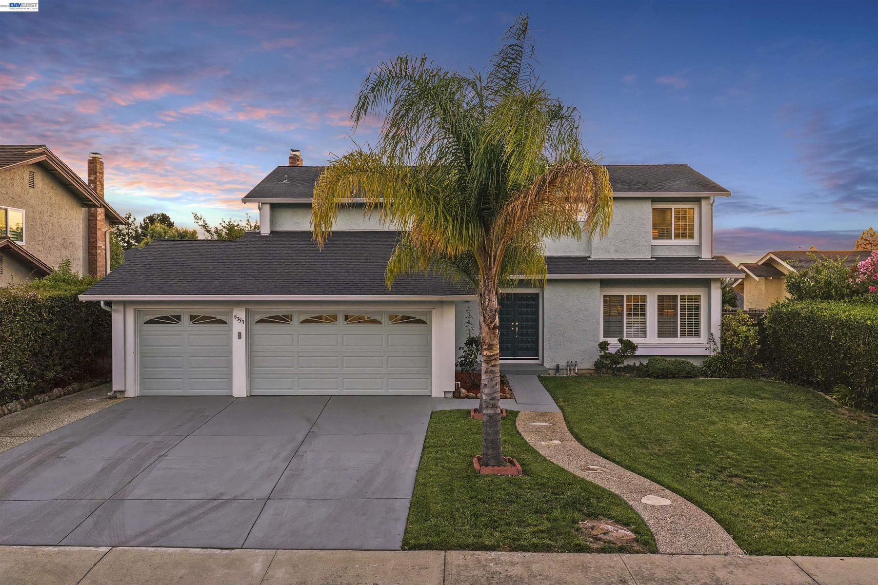 5333 Creek Estates at twilight with palm trees and a three-car garage