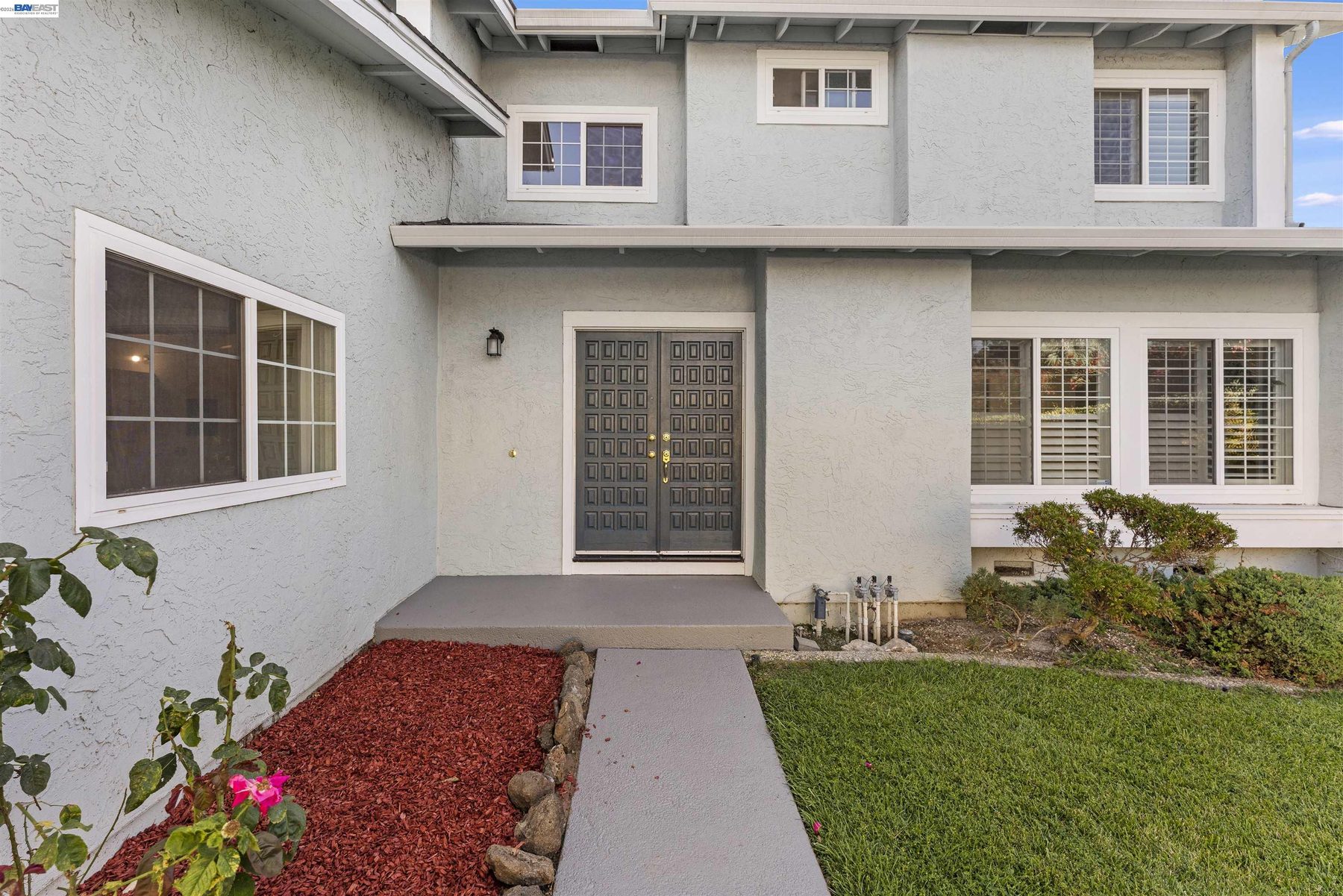 Landscaped walkway leading to the double front doors